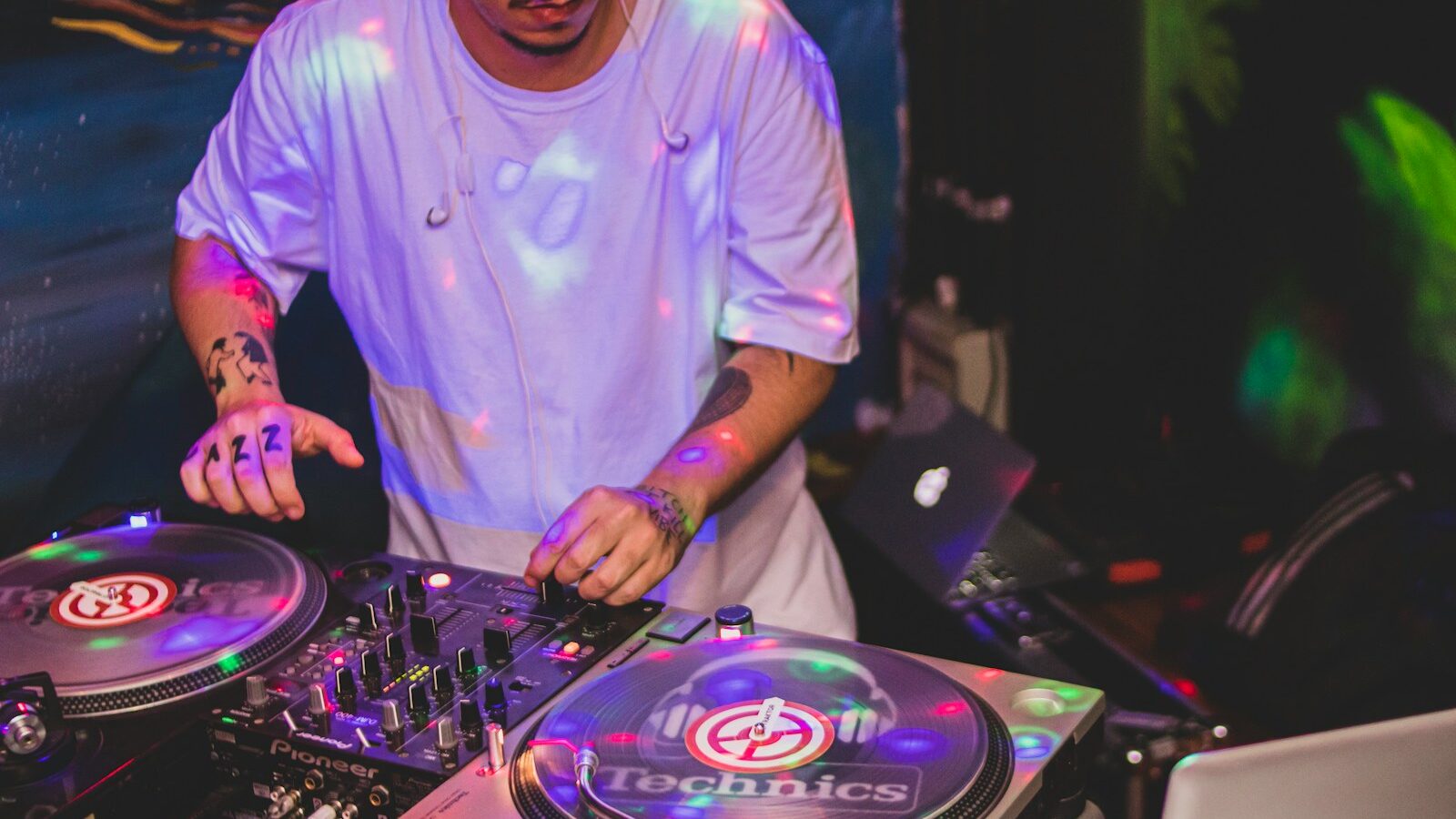 man in blue crew neck t-shirt playing dj controller