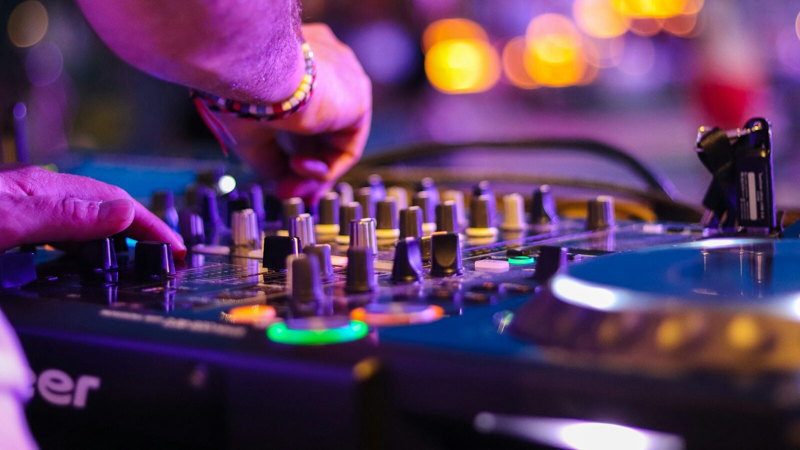 DJ controlling turntable at night