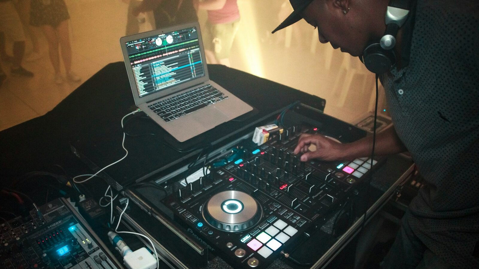 man wearing black shirt in front of DJ mixer