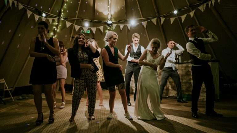 group of people dancing at a wedding